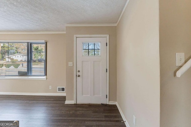 foyer entrance featuring ornamental molding, dark hardwood / wood-style floors, and a textured ceiling