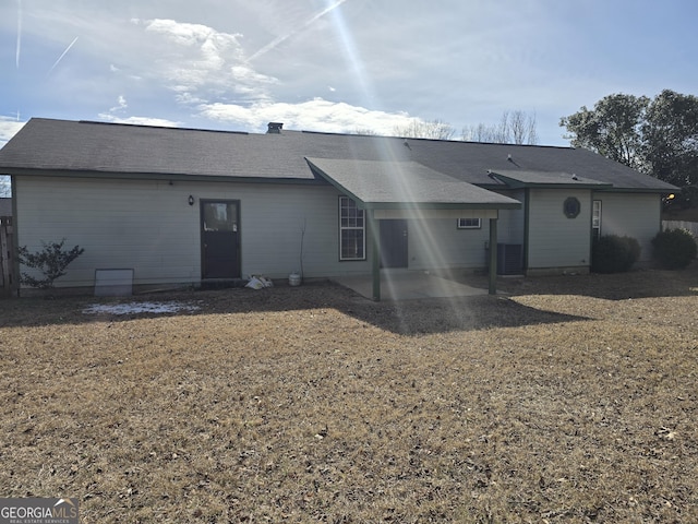 back of house with central AC unit