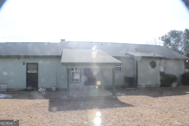 rear view of property featuring a patio area and central air condition unit