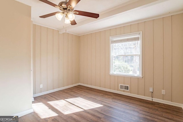 spare room with ceiling fan and wood-type flooring