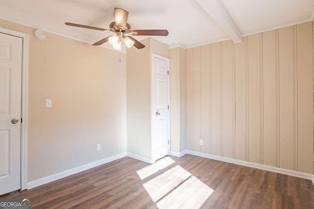 unfurnished bedroom with dark hardwood / wood-style flooring, beam ceiling, and ceiling fan