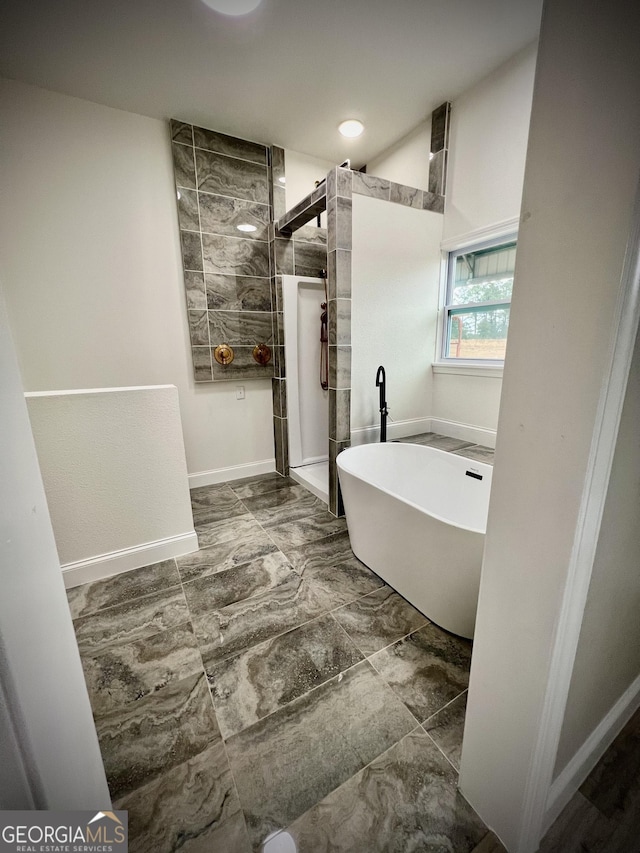 bathroom featuring separate shower and tub