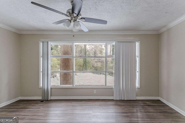 empty room with ornamental molding, dark hardwood / wood-style floors, and a textured ceiling