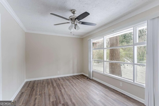 unfurnished room featuring crown molding, ceiling fan, a textured ceiling, and light hardwood / wood-style flooring