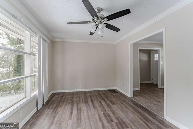 empty room with crown molding, ceiling fan, hardwood / wood-style floors, and a textured ceiling