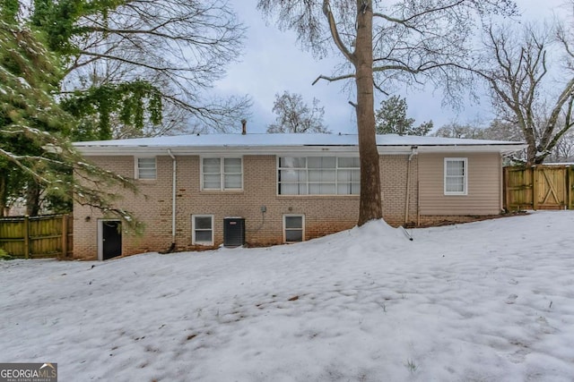 snow covered house with cooling unit