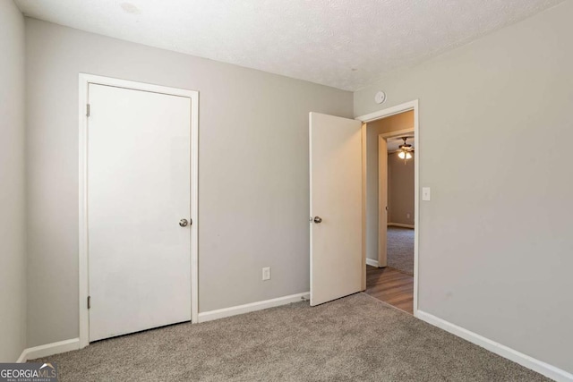 unfurnished bedroom with carpet flooring and a textured ceiling