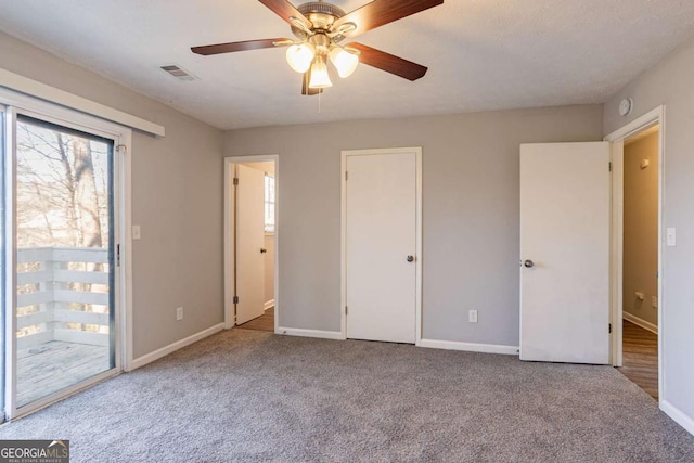 unfurnished bedroom featuring light carpet and ceiling fan