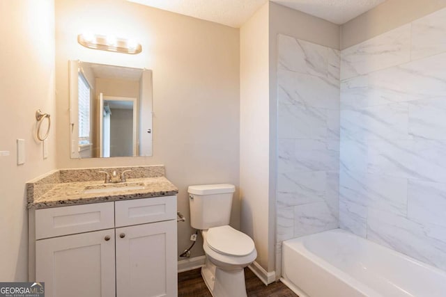 bathroom featuring vanity, toilet, and a textured ceiling