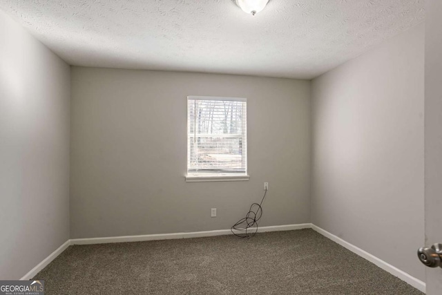 spare room with carpet floors and a textured ceiling