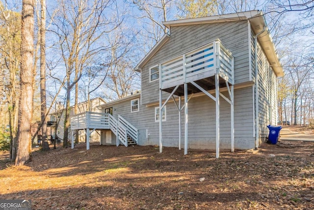 rear view of property featuring a deck