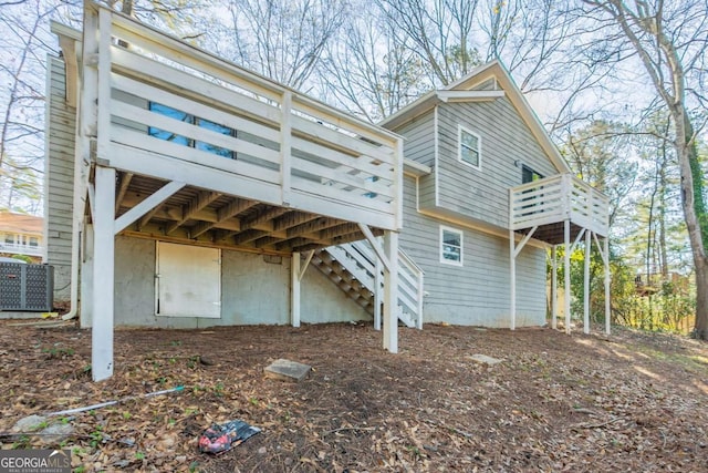 back of house featuring central AC and a deck