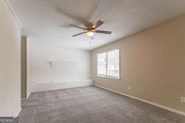 carpeted spare room featuring ceiling fan and a textured ceiling