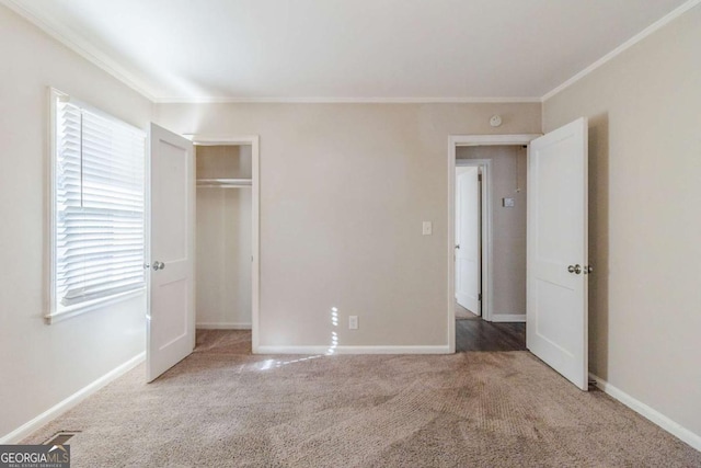 unfurnished bedroom featuring ornamental molding, a closet, and carpet