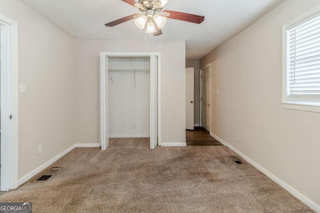 unfurnished bedroom featuring ceiling fan, carpet floors, and a closet