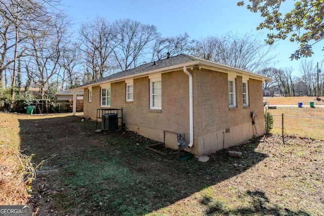 view of side of home with central AC