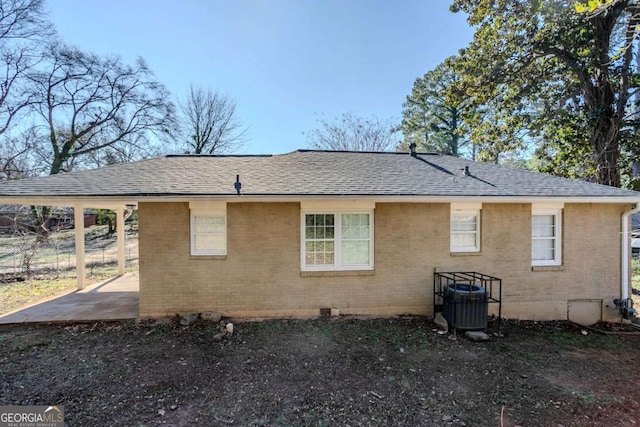 rear view of house with central AC