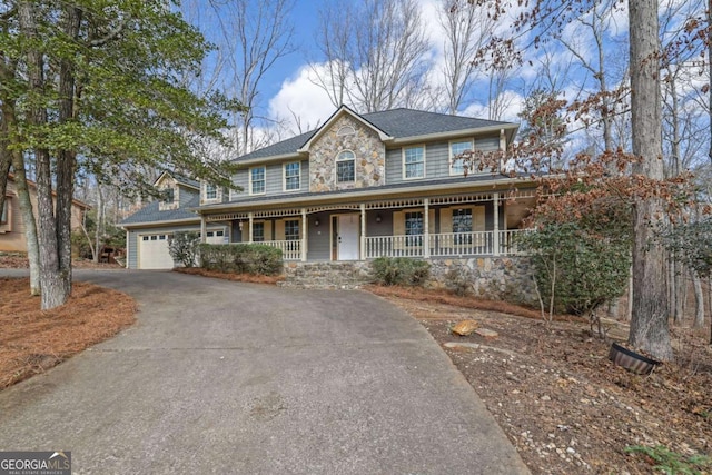 view of front of house with a porch and a garage