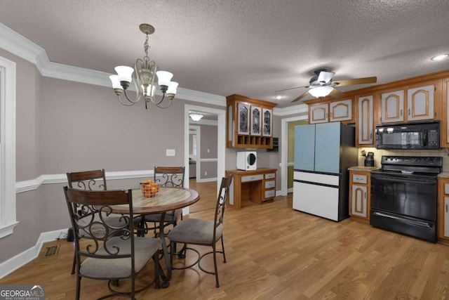 kitchen featuring pendant lighting, crown molding, black appliances, a textured ceiling, and light wood-type flooring