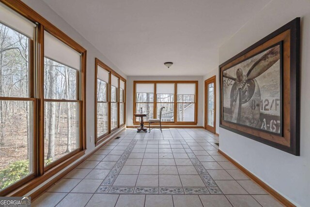 unfurnished sunroom with a wealth of natural light