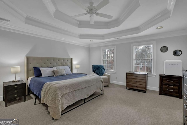 bedroom with ornamental molding, light colored carpet, ceiling fan, and a tray ceiling