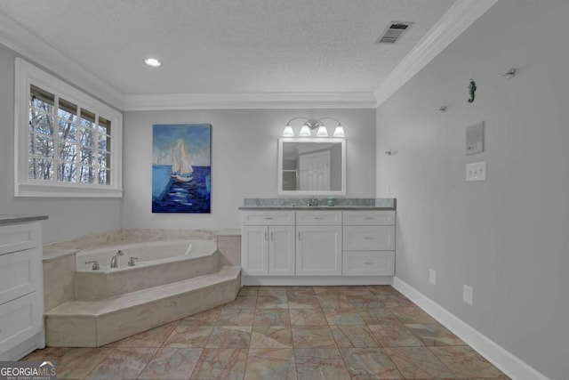 bathroom featuring vanity, ornamental molding, a bathing tub, and a textured ceiling