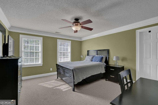 carpeted bedroom featuring ornamental molding, a textured ceiling, and ceiling fan