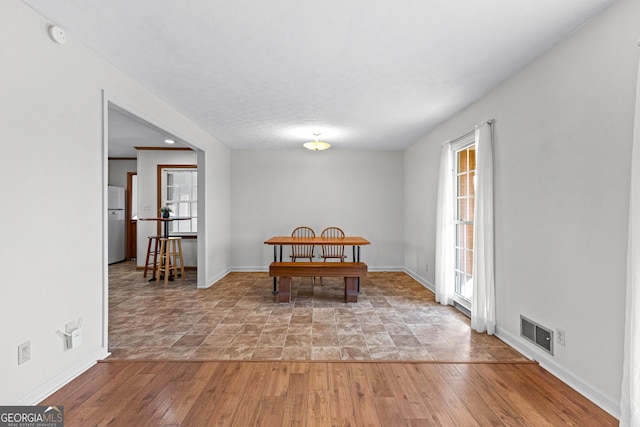 dining space with hardwood / wood-style flooring