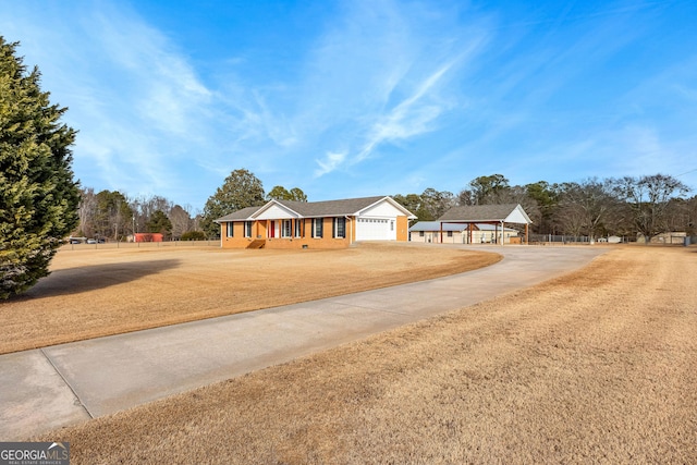 single story home featuring a gazebo, a garage, and a front lawn