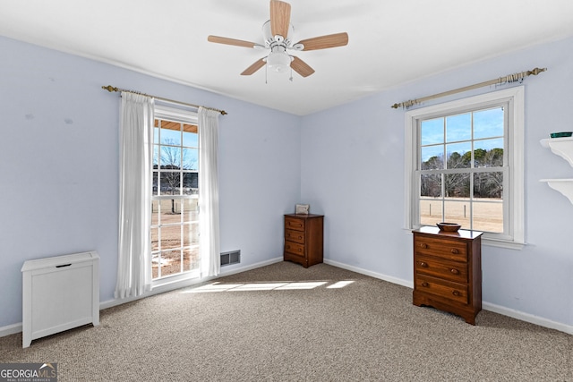 unfurnished bedroom with ceiling fan and carpet flooring