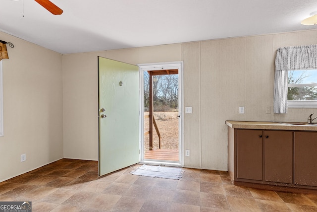 entryway featuring a healthy amount of sunlight, sink, and ceiling fan