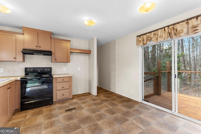 kitchen featuring black range with electric stovetop and light brown cabinets