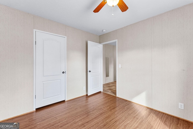 unfurnished bedroom featuring wood-type flooring and ceiling fan