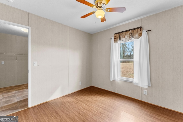 empty room featuring hardwood / wood-style floors and ceiling fan