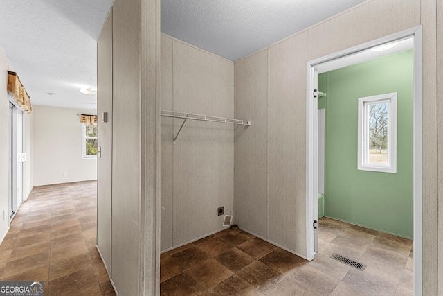 washroom featuring hookup for an electric dryer and a textured ceiling