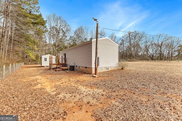 view of side of property featuring a shed