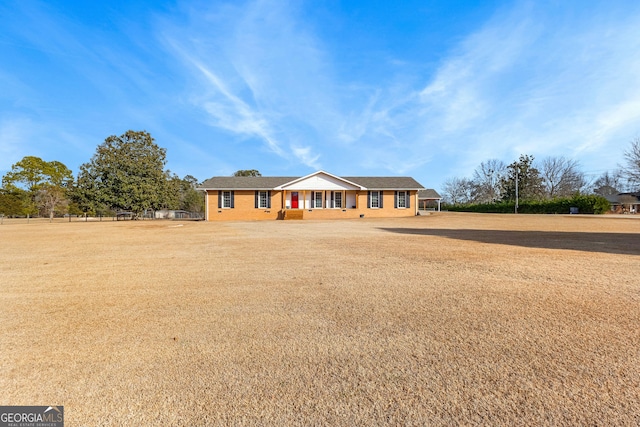 ranch-style home with a front yard and covered porch