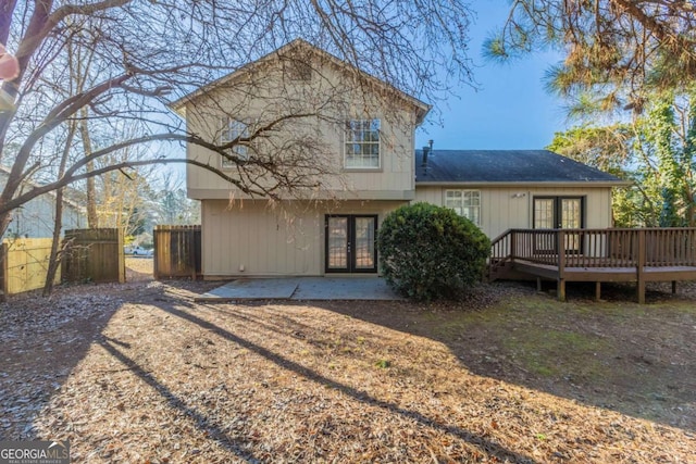 rear view of house featuring a patio area, french doors, and a deck