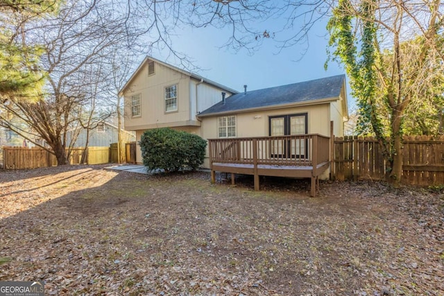 back of house with a wooden deck