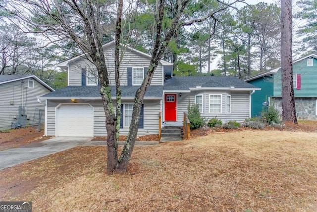 tri-level home with a garage and a front yard