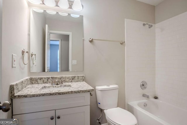 full bathroom with vanity, tiled shower / bath, and toilet