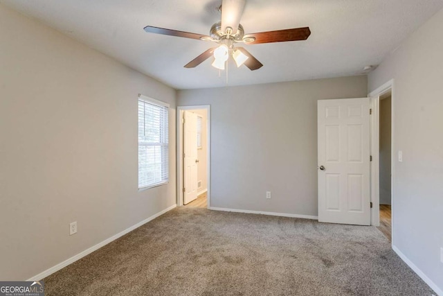 unfurnished room featuring ceiling fan and light colored carpet