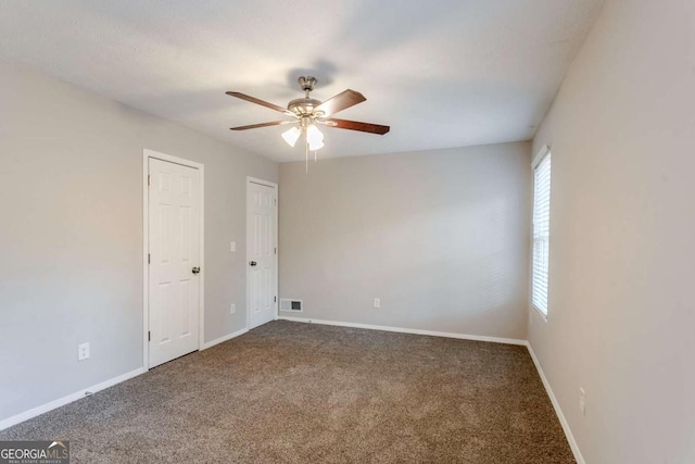 carpeted empty room featuring plenty of natural light and ceiling fan