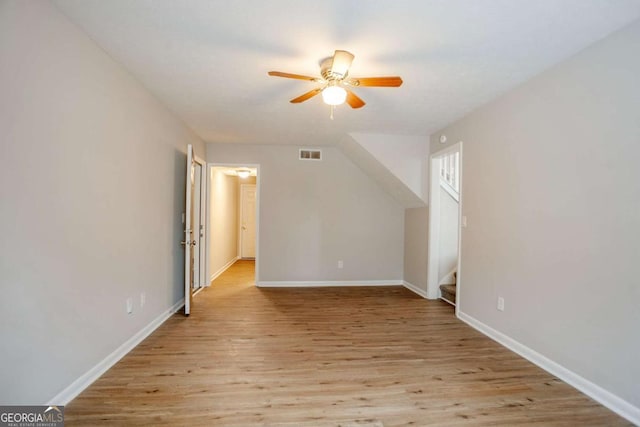 additional living space with ceiling fan and light wood-type flooring