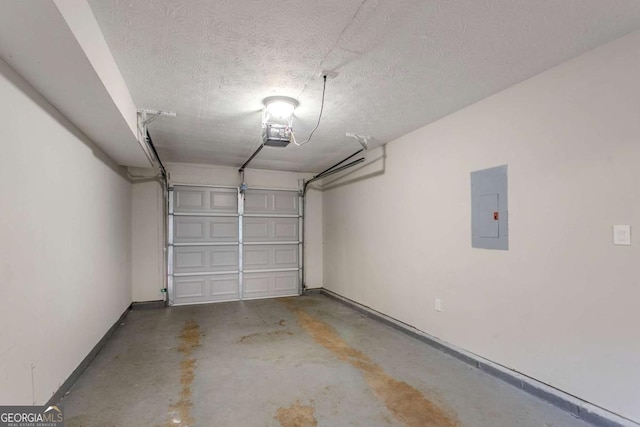 garage with a garage door opener and electric panel