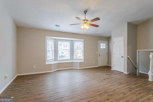 unfurnished living room with hardwood / wood-style floors and ceiling fan