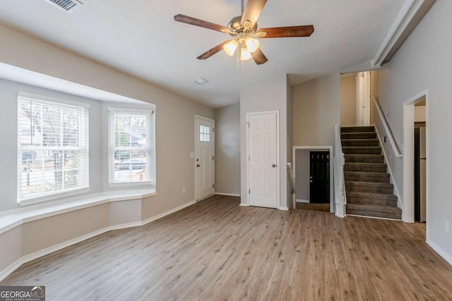 entrance foyer with ceiling fan and light hardwood / wood-style flooring