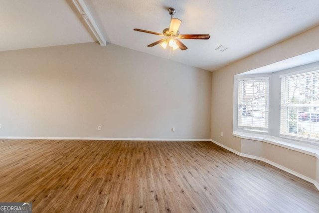 spare room featuring lofted ceiling with beams, ceiling fan, and light hardwood / wood-style flooring