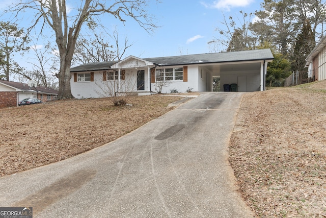 ranch-style house featuring a carport