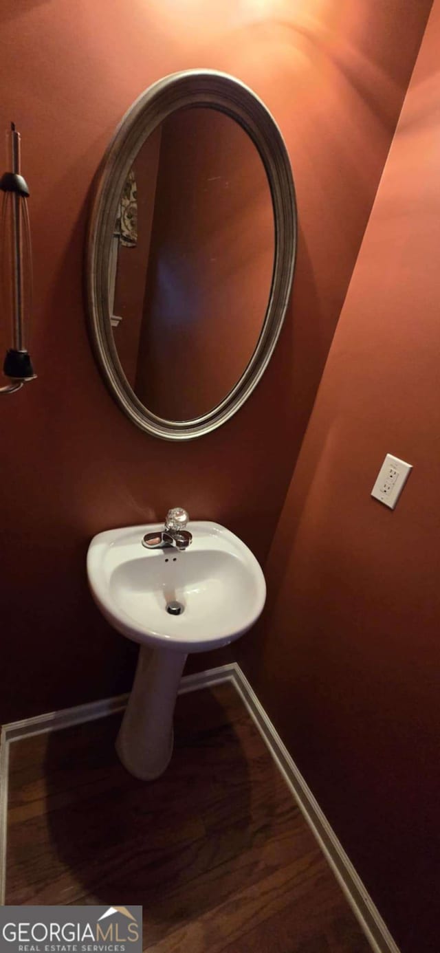 bathroom featuring wood-type flooring and sink